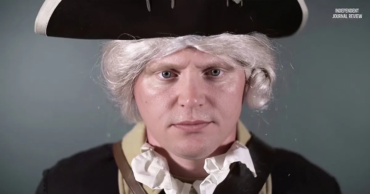 A person in colonial attire with a powdered wig and tricorn hat is seen against a plain background.