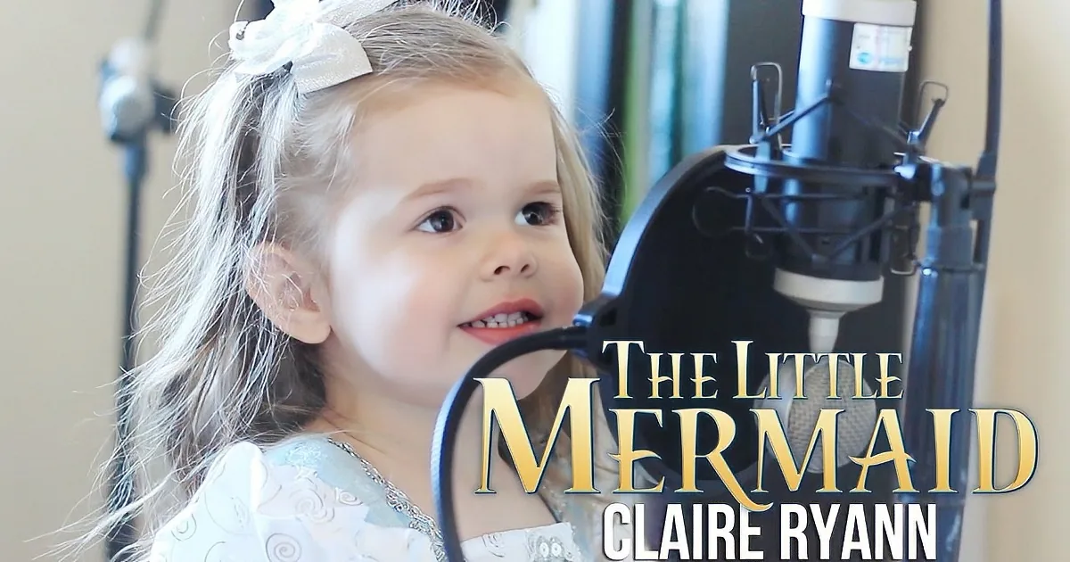 A young girl with blonde hair and a white bow smiles near a microphone, with "The Little Mermaid" text overlay.