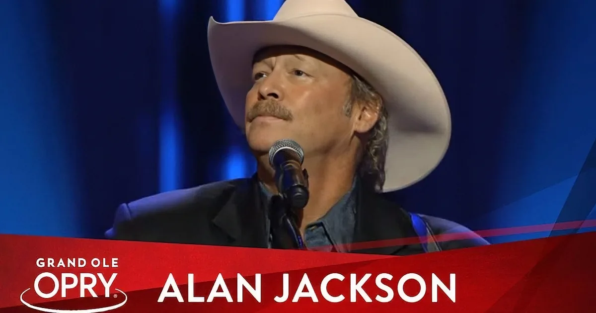 Alan Jackson, wearing a cowboy hat, sings at the Grand Ole Opry.