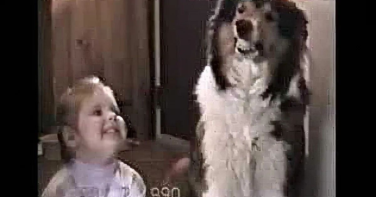 A baby and a dog are looking up, with the dog appearing to bark or howl.
