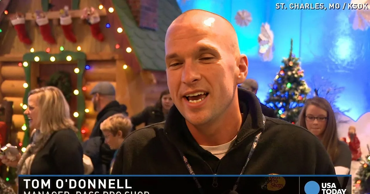 Tom O'Donnell, Bass Pro Shop manager, smiles in a festive Christmas setting with lights and decorations.