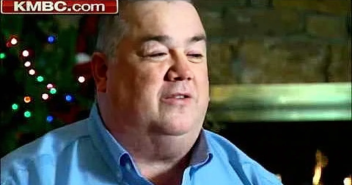 A man in a blue shirt is speaking, with a blurred background and a KMBC.com logo in the corner.