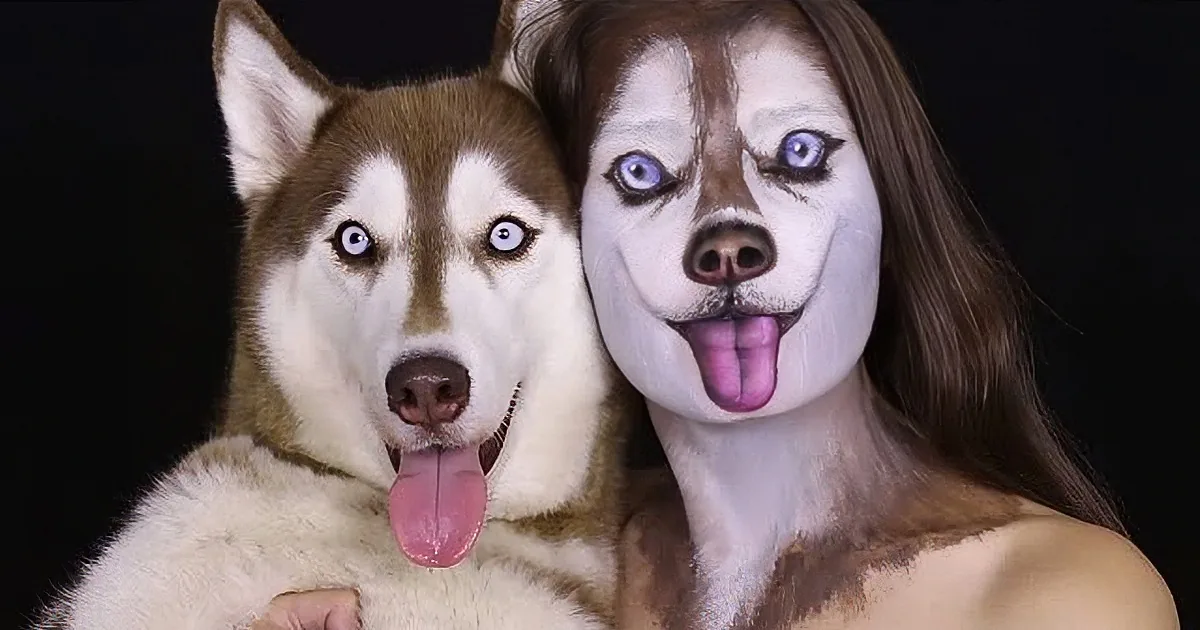 A woman with a husky face paint and a real husky dog with matching expressions.