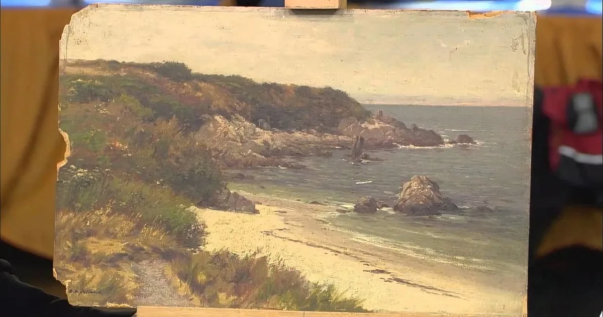 A painting depicts a serene coastal scene with a sandy beach, rocky cliffs, and gentle waves under a soft sky.