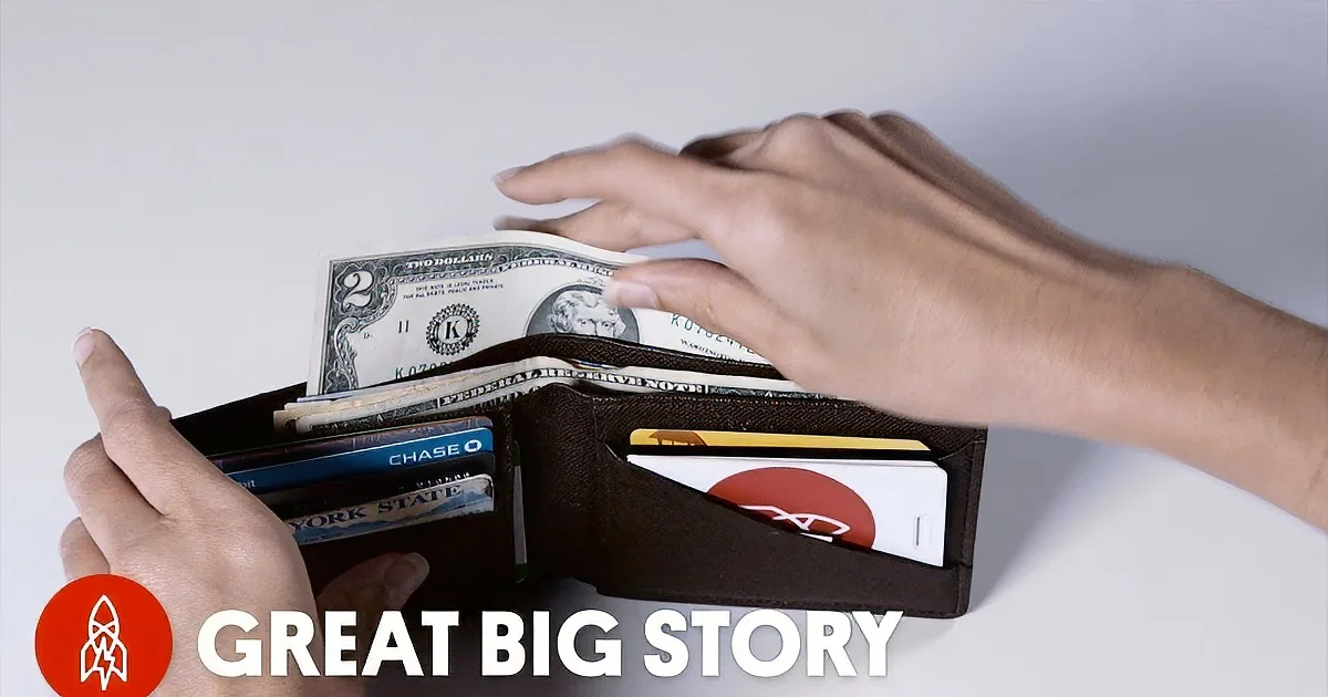 A person holds a wallet with cash, cards, and a Chase card with a lightning bolt logo.
