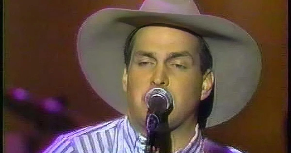 A man in a cowboy hat sings into a microphone, wearing a striped shirt, with a blurred background and small inset images.