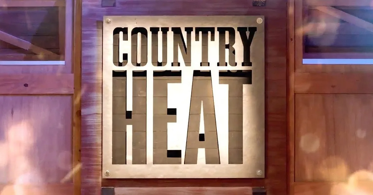 A sign reading "COUNTRY HEAT" is mounted on a wooden wall with a warm, glowing background.
