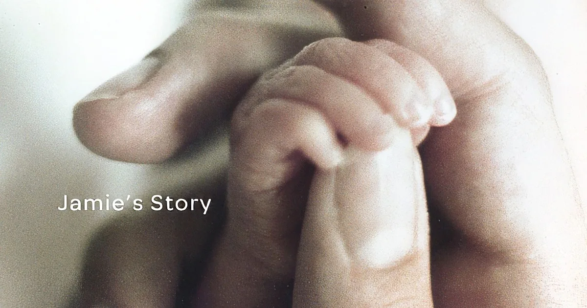 A close-up of a baby's hand gripping an adult's finger, symbolizing connection and care.