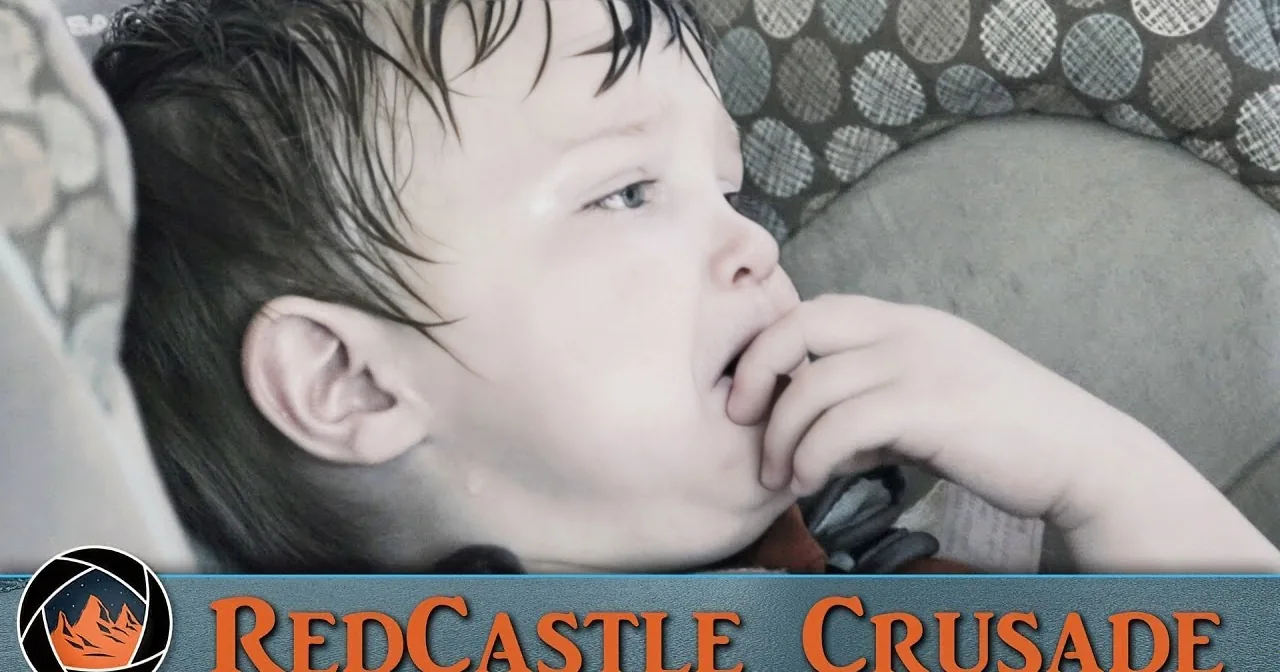 A child rests in a patterned chair, hand near mouth, with "RedCastle Crusade" logo at the bottom.