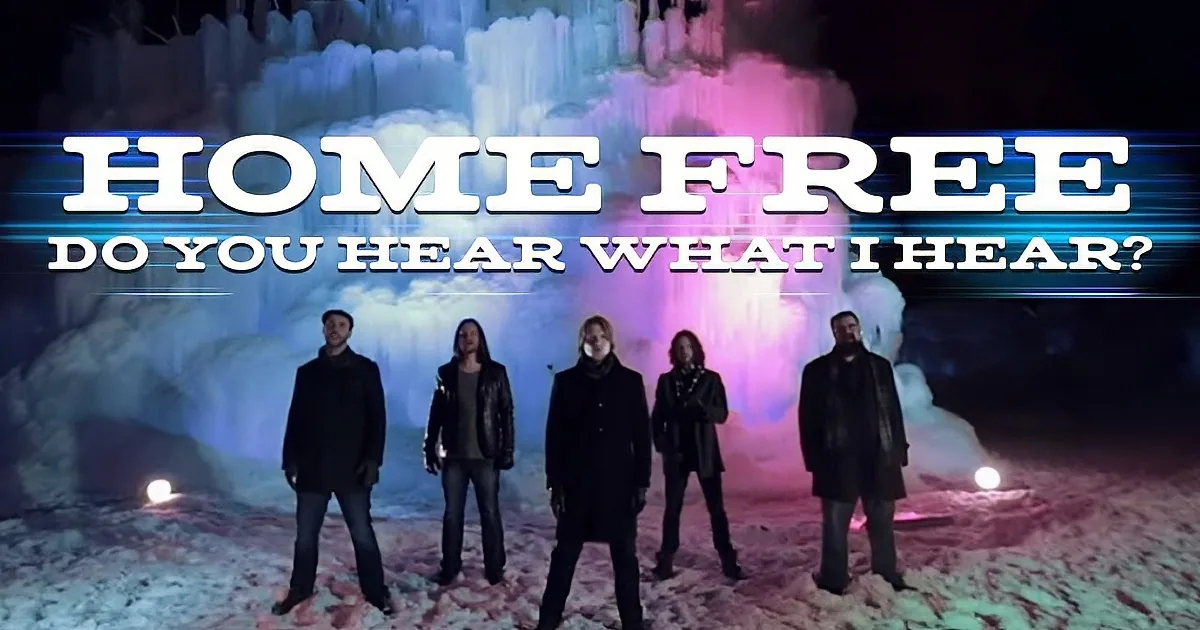 A group of six people stands in front of a colorful, icy backdrop with the text "HOME FREE: DO YOU HEAR WHAT I HEAR?"...
