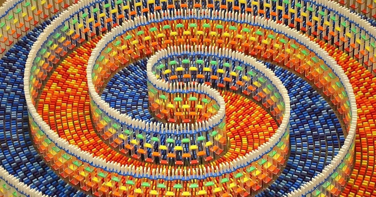 A colorful, spiral-shaped structure composed of small, rectangular blocks in various colors.