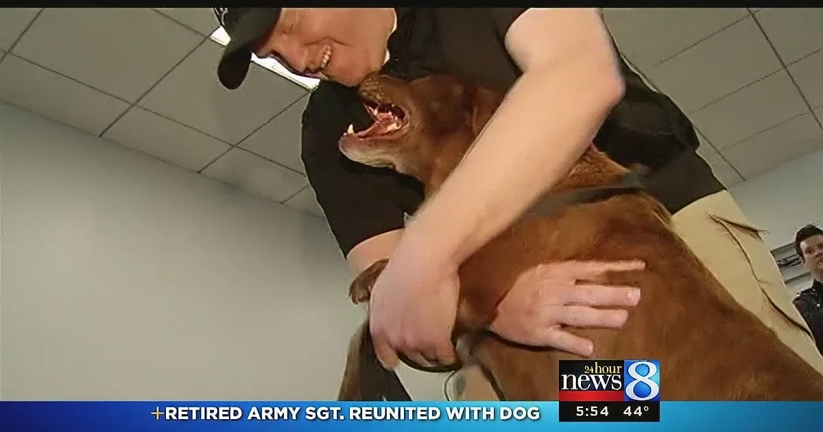 A retired Army Sgt. is reunited with his dog, smiling and embracing in a heartfelt moment.