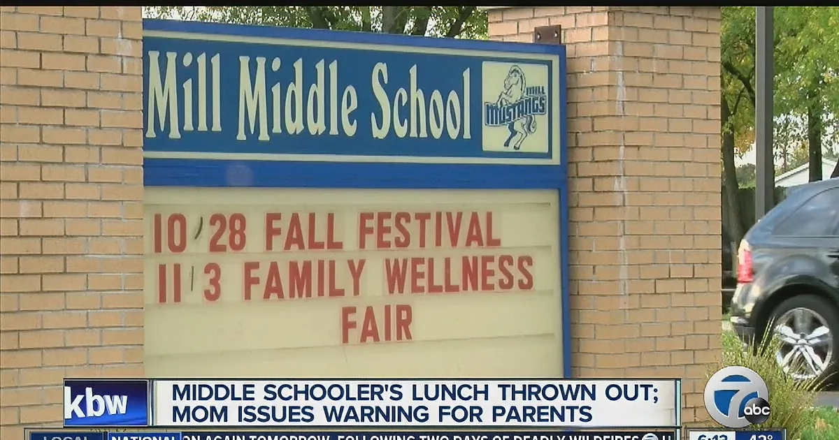 A sign for Mill Middle School displays a fall festival and mentions a middle schooler's lunch thrown out.