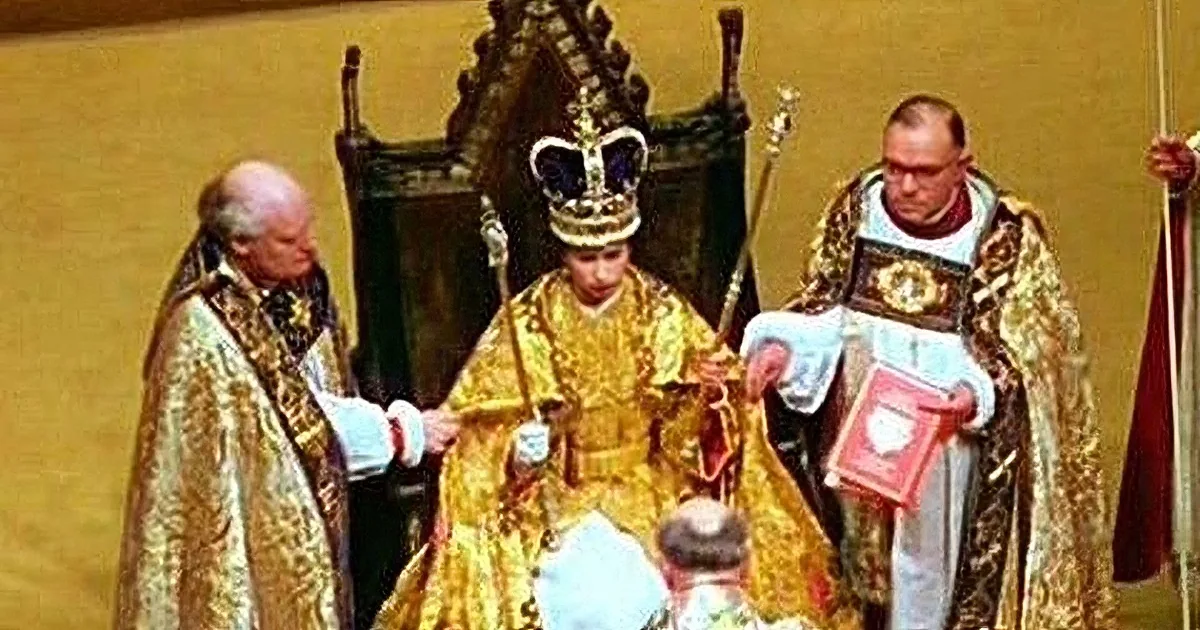 A person in ornate gold robes and a crown is being anointed by another in similar attire, surrounded by ceremonial figures.