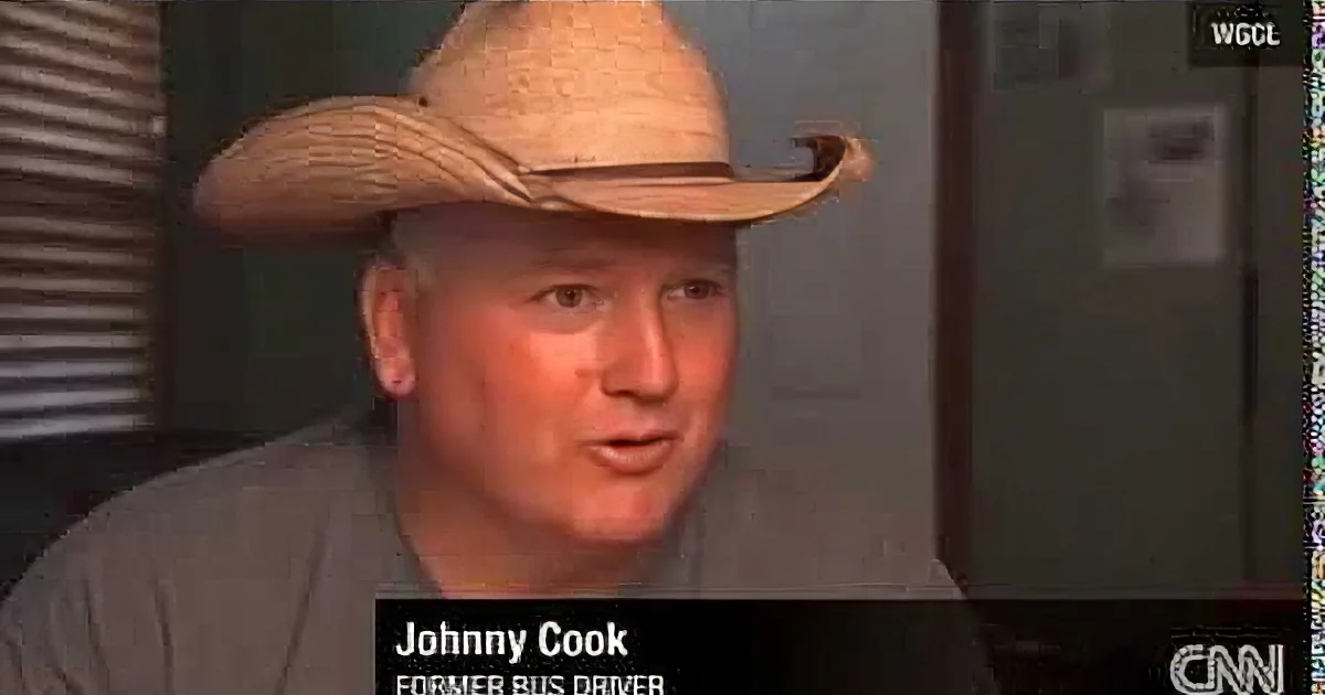 A man wearing a straw cowboy hat is speaking on a CNN broadcast, identified as Johnny Cook, former B.U. player.