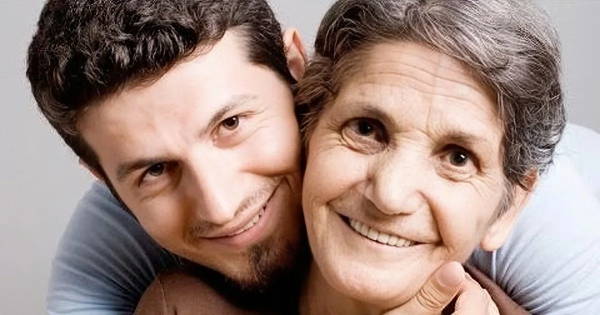 A young man and an older woman are smiling closely together, creating a collage of their faces.