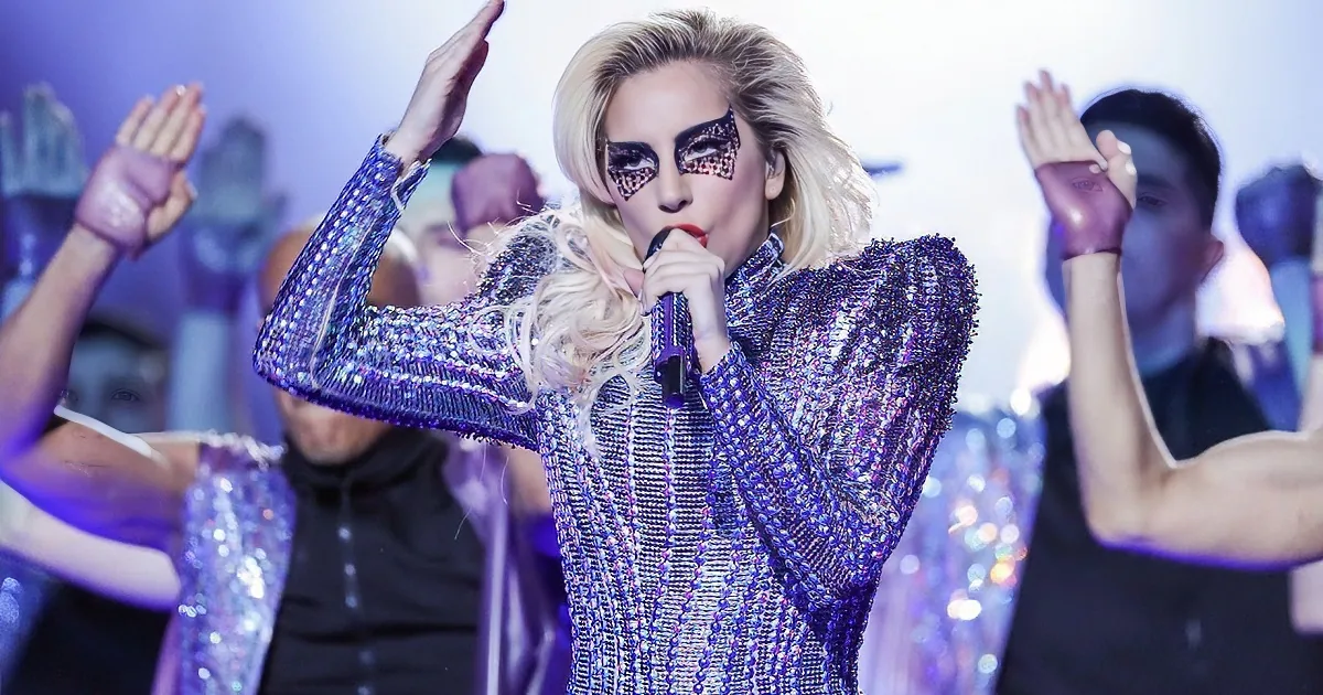 Lady Gaga performs on a high platform with smoke and lights at Super Bowl LI.