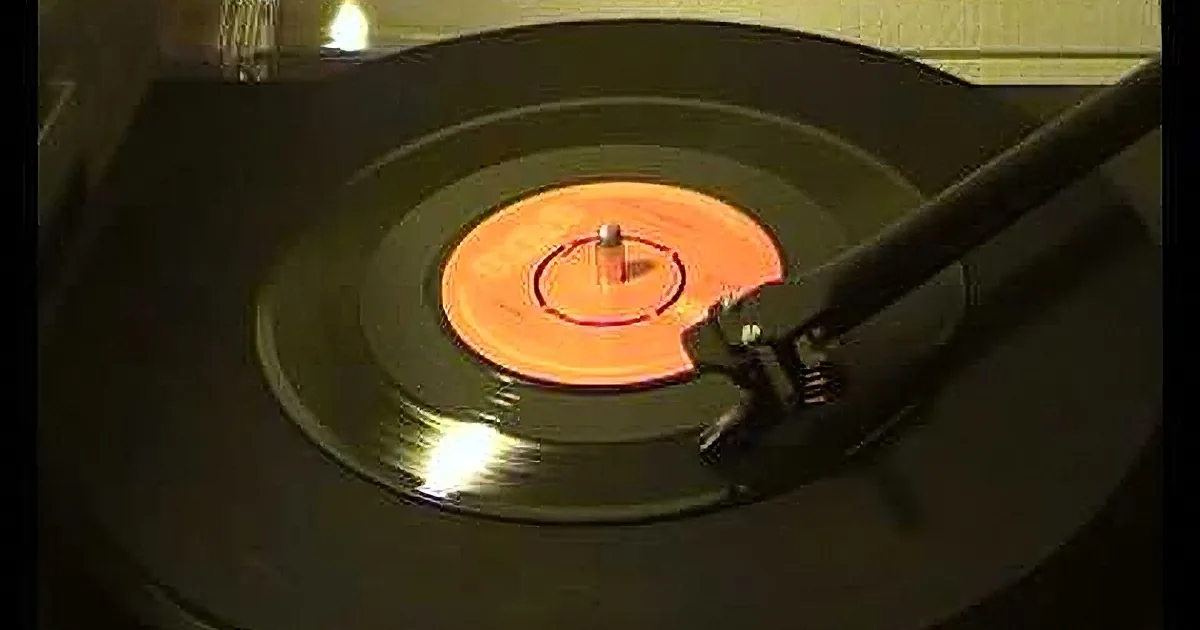 A vinyl record spins on a turntable with a stylus on the needle.