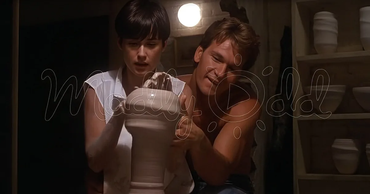 A man and woman are holding a large, white, cylindrical object in a dimly lit room with shelves of pottery.