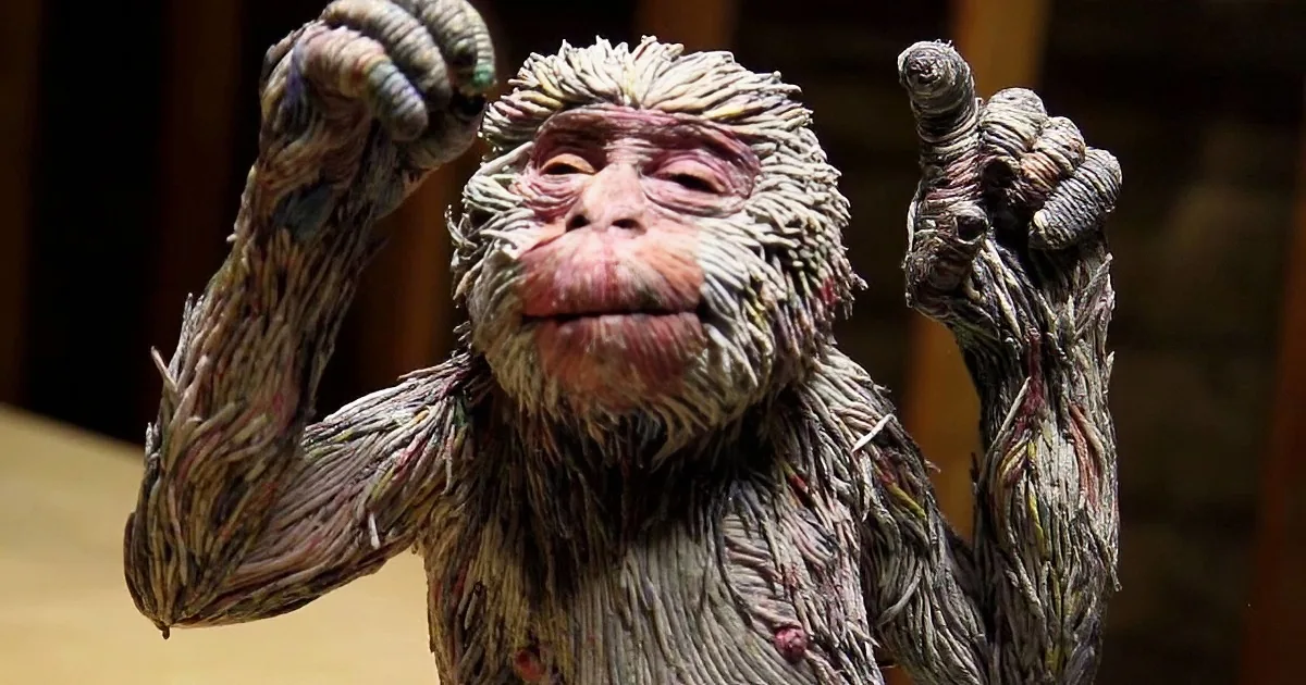 A monkey-like figure with textured, matted fur and raised arms.