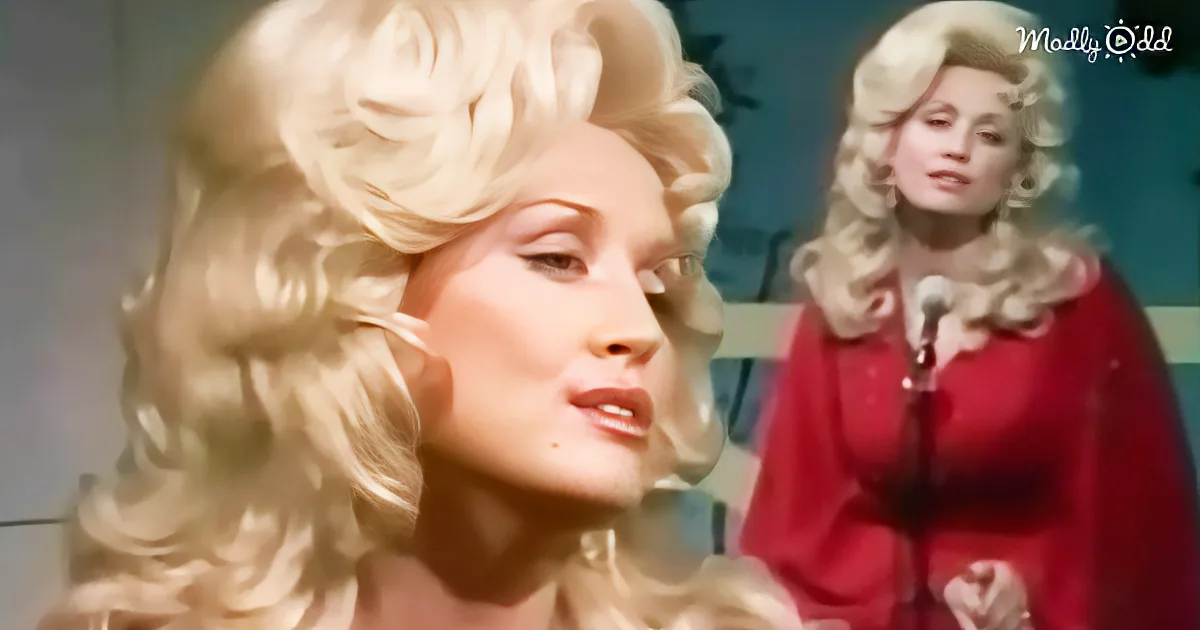 A woman with voluminous blonde hair and a red outfit is singing into a microphone.