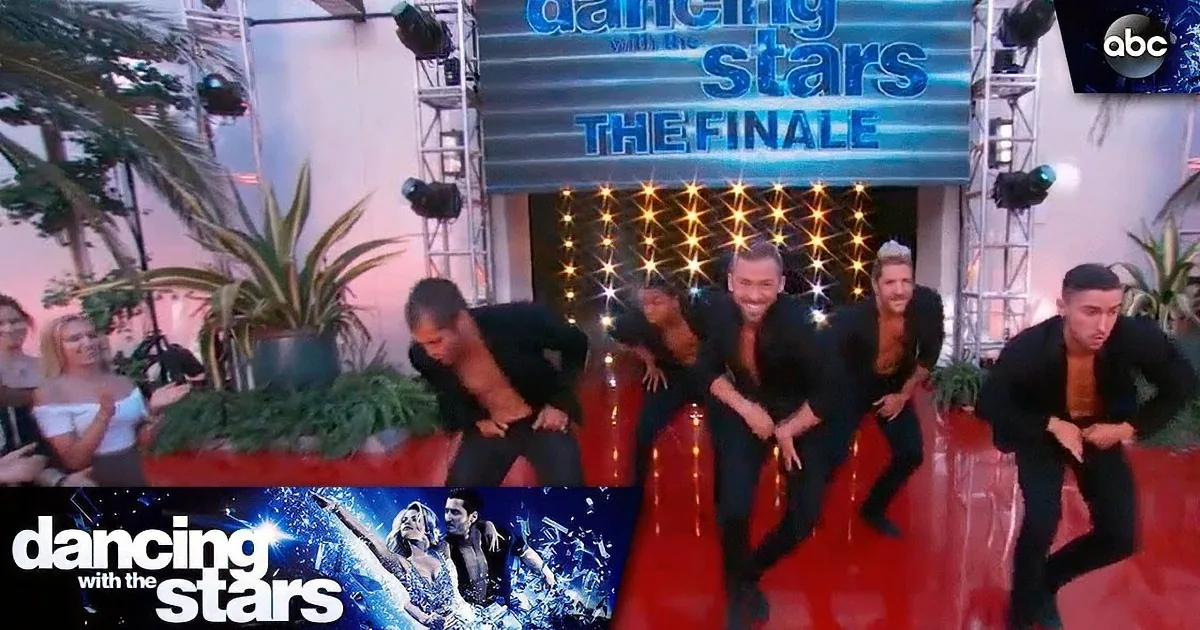 Men in suits dance on a red stage with "Dancing with the Stars: The Finale" backdrop.