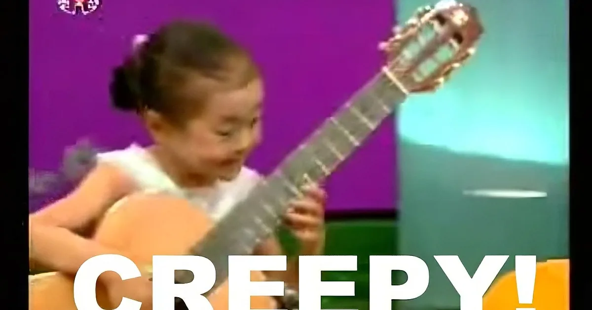 A young girl is playing a guitar with a purple background and the word "CREEPY!" overlaid.