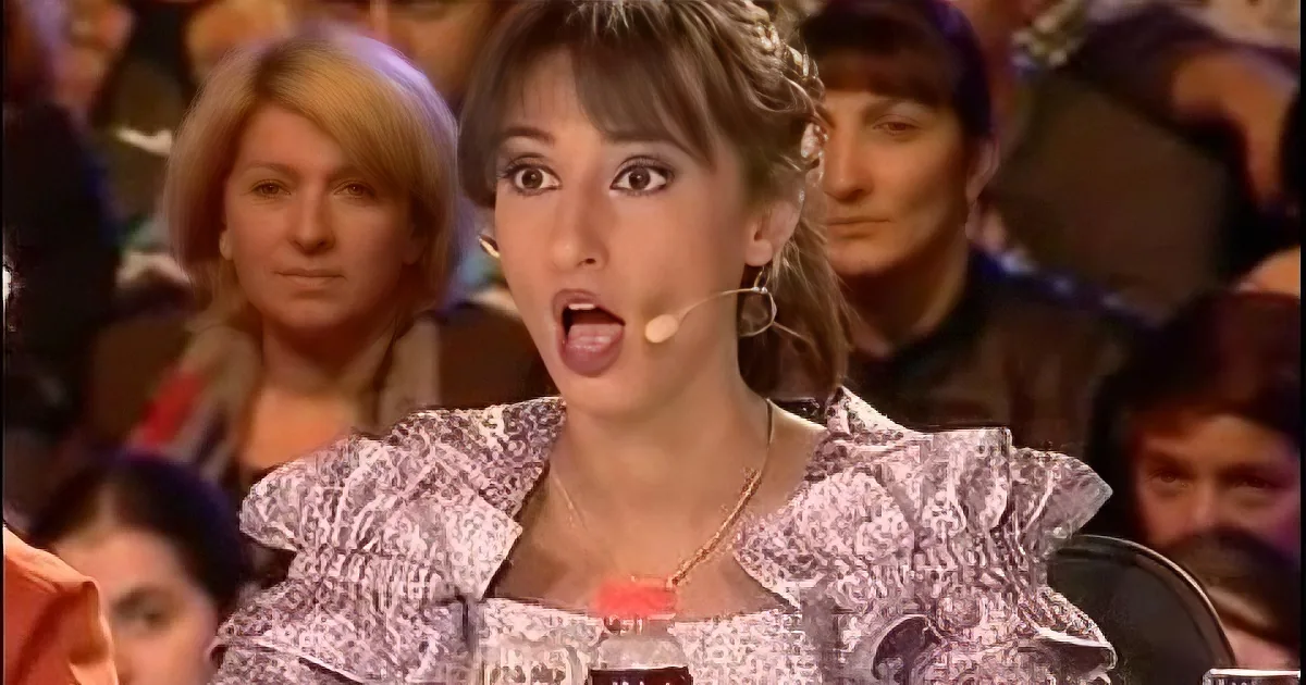 A woman with a surprised expression, wearing a headset and a patterned blouse, is in the foreground.