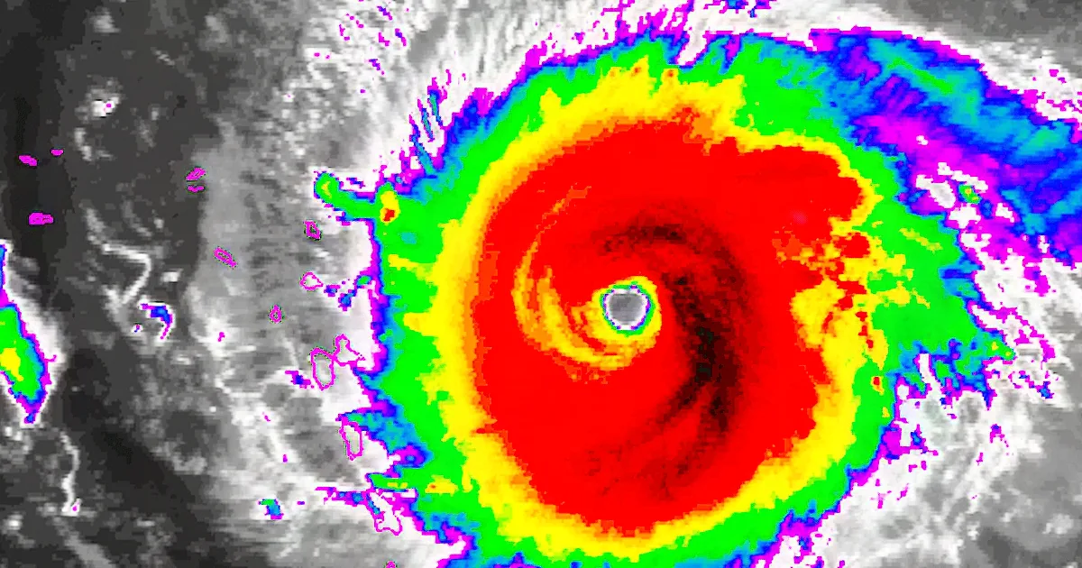A satellite image shows a hurricane with a central eye surrounded by swirling clouds in vibrant colors.