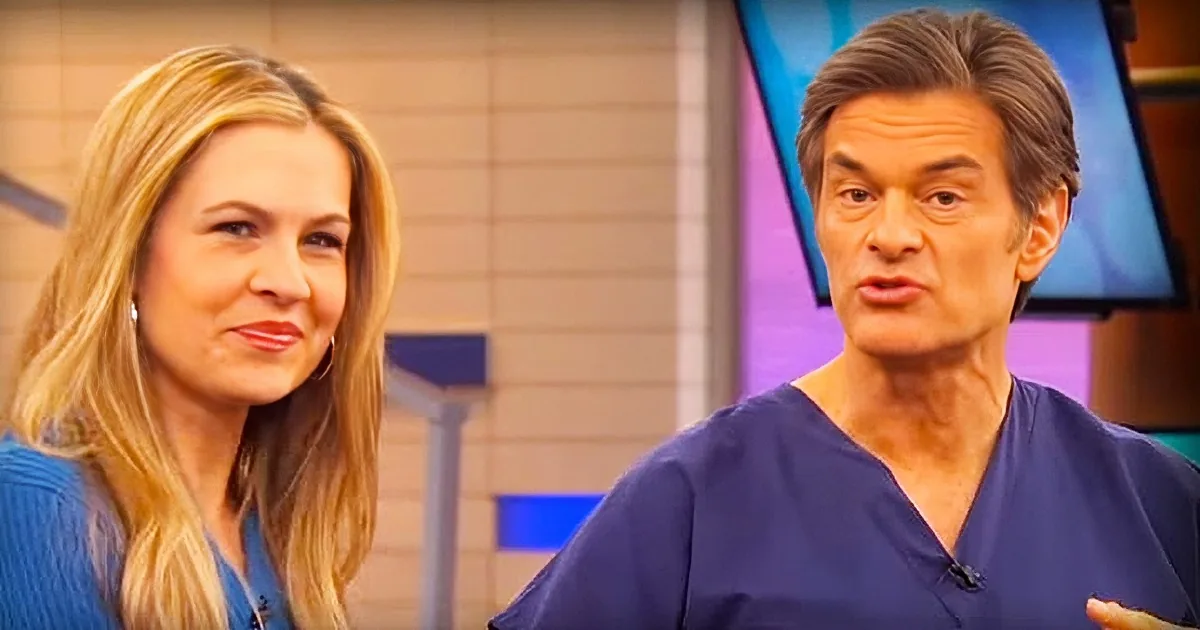 A man in a blue shirt is speaking, with a woman in a similar outfit beside him, both in a studio setting.