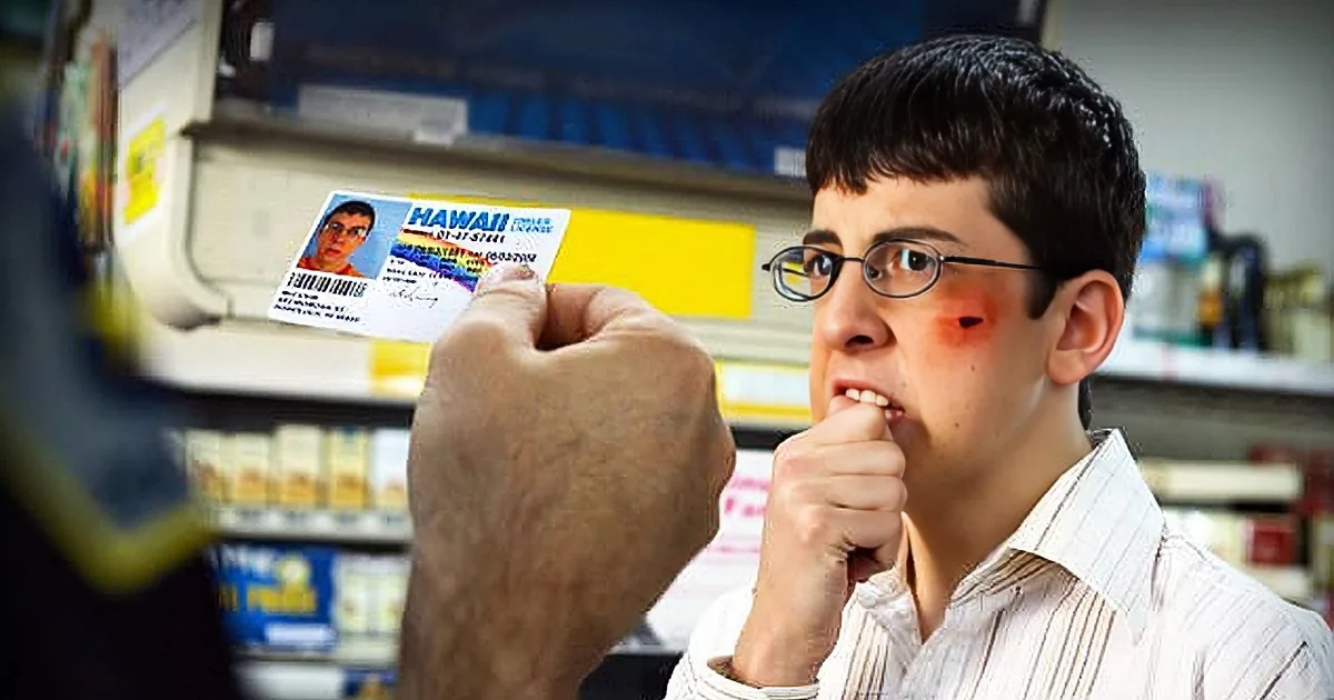 A man with a bruised cheek holds a ticket labeled "Hawaii" while another hand holds a small object near his mouth.