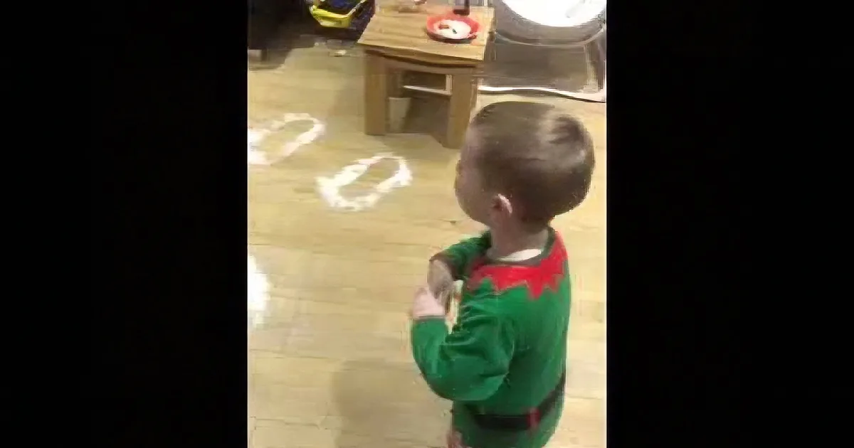 Santa''s Snowy Footprints Bring Holiday Joy to a Cute Little Boy