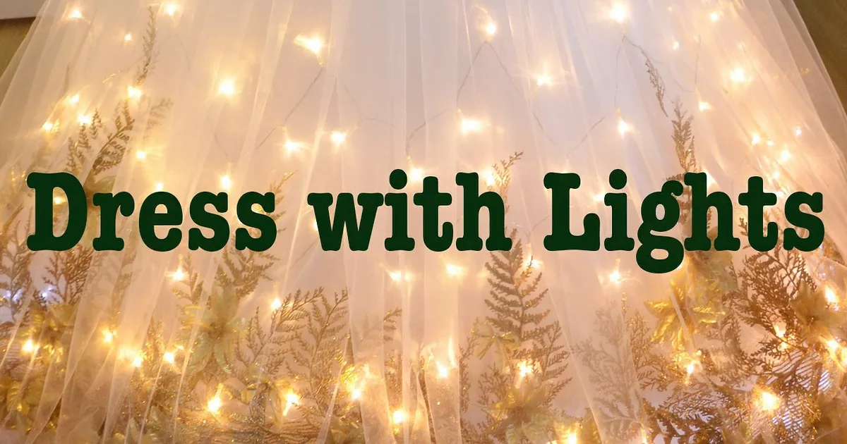 I see a white fabric canopy with fairy lights and leaf designs hanging from the ceiling.