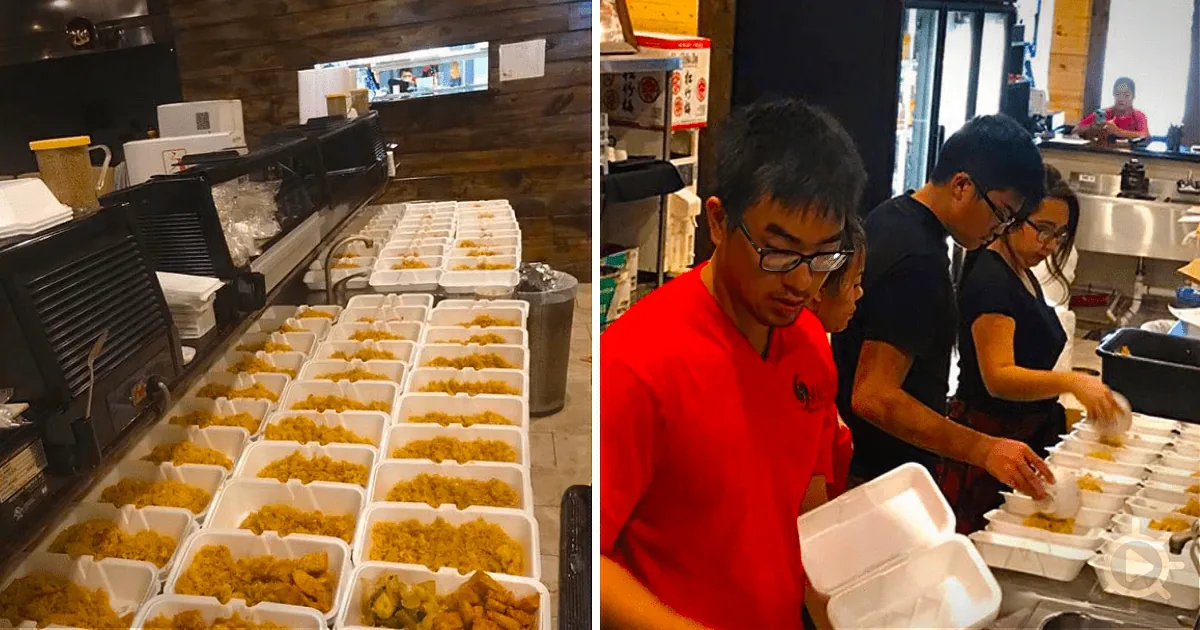 Workers in a kitchen prepare and package food in white containers.