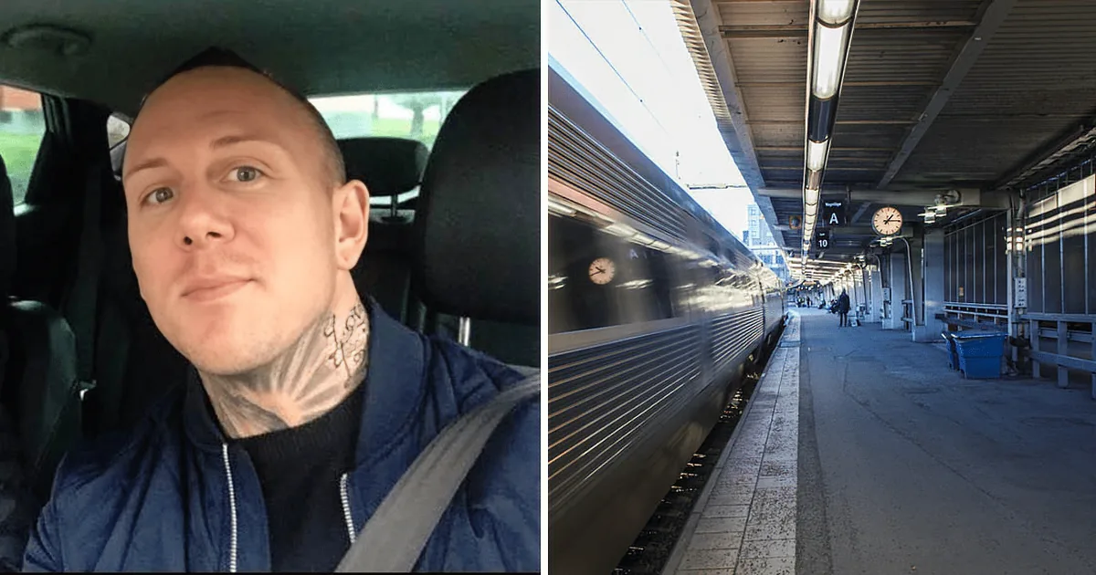 A man with a shaved head and neck tattoo is in a car, while a train speeds past at a station with clocks and signs.