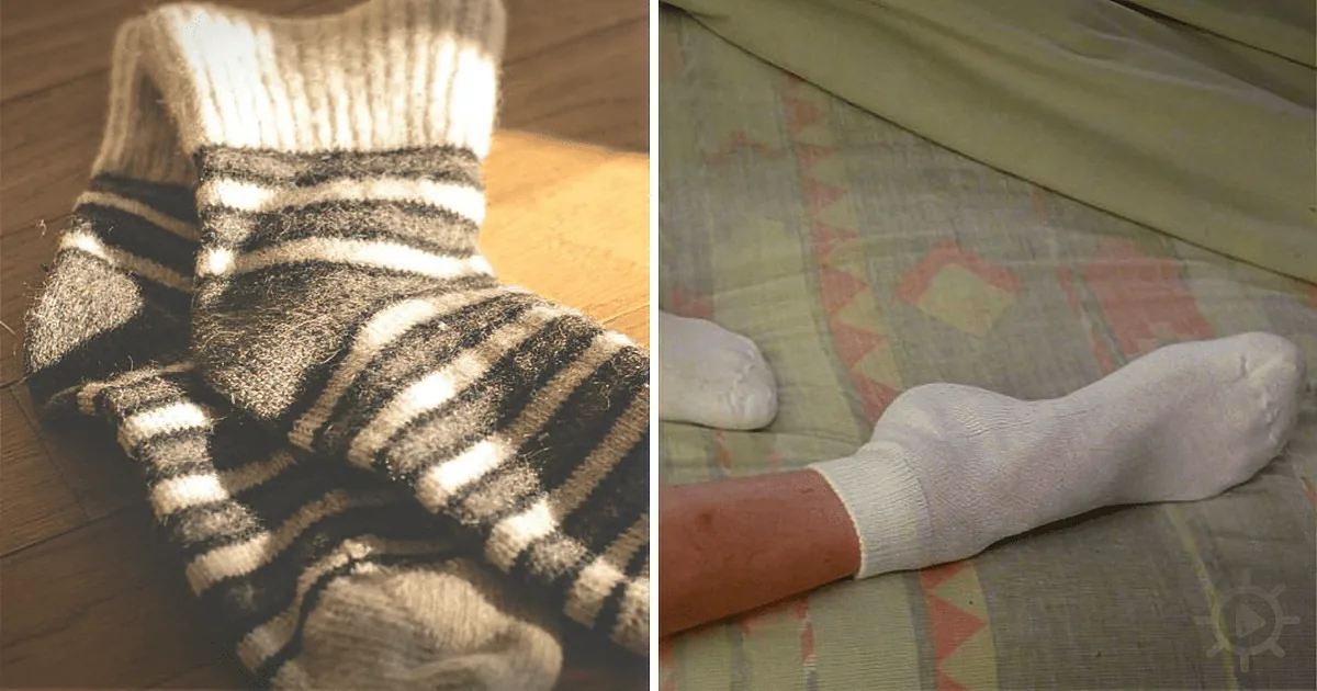 A pair of worn, striped socks on a wooden floor and a white sock on a patterned bedspread.