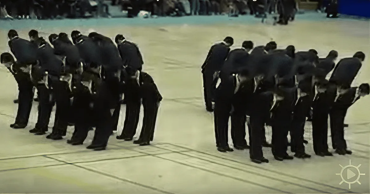 A group of men in suits are huddled together, seemingly engaged in a discussion or activity.