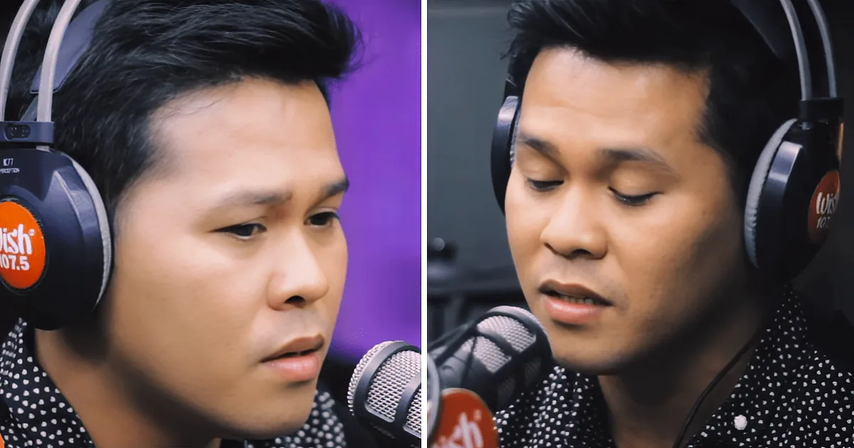 A man wearing headphones and a polka-dot shirt is speaking into a microphone in a studio setting.