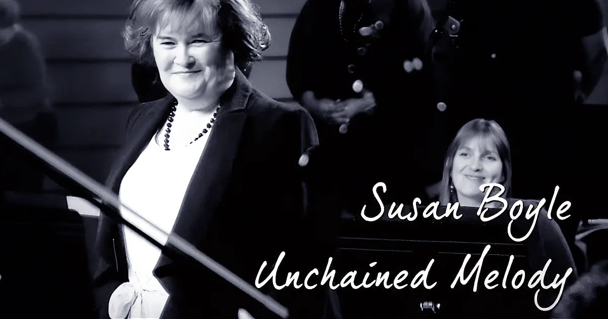 Susan Boyle smiles at piano, "Unchained Melody" text overlaid, black-and-white image.