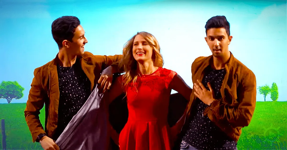 A woman in a red dress is flanked by two men in brown jackets, with a pastoral background.