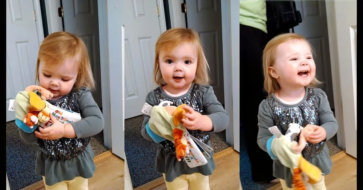 A young child with blonde hair, wearing a grey top and yellow pants, is holding a stuffed animal and smiling in various...
