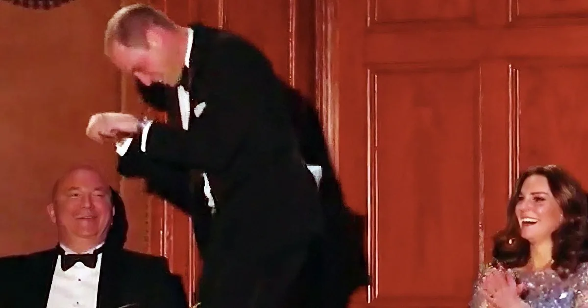 A man in a tuxedo is playfully leaning forward, while a woman in a sparkly dress claps and smiles.