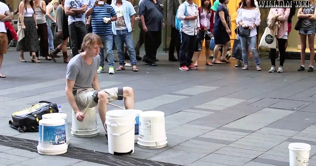 Busker Pounds out Some Serious Beats With His Drumsticks and a Few Buckets