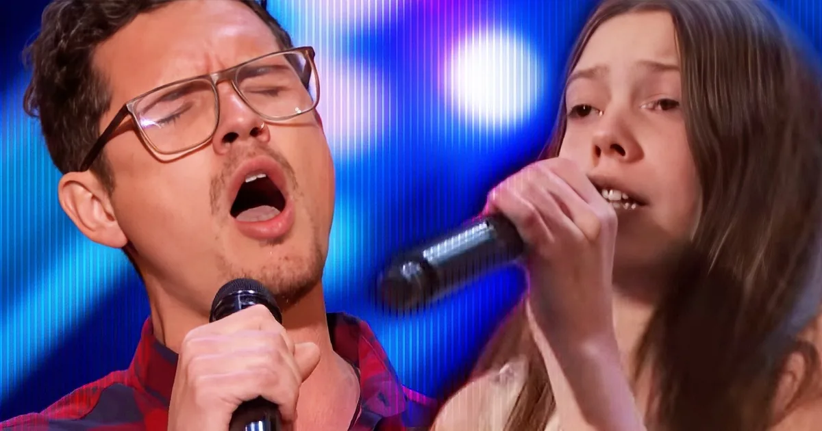 A man and a woman sing passionately into microphones on a stage with blue lighting.