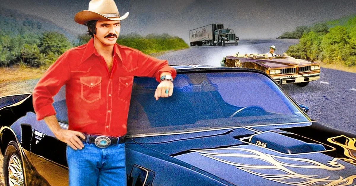 A man in a red shirt and cowboy hat leans on a blue muscle car with flames, while a gold car and truck race behind him.