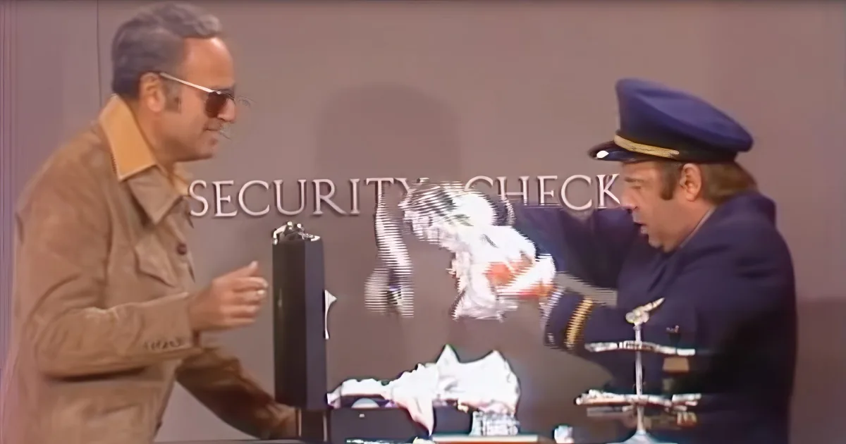 A security guard checks a man's bag at a security checkpoint.