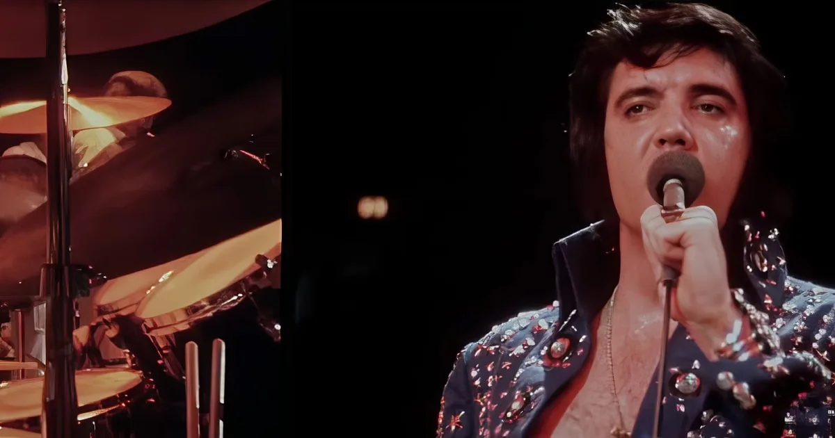 Elvis Presley in a glittery outfit sings into a microphone on stage.