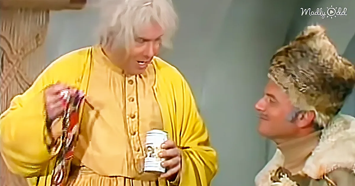A person in a yellow robe holds a can, interacting with another person in a white outfit.