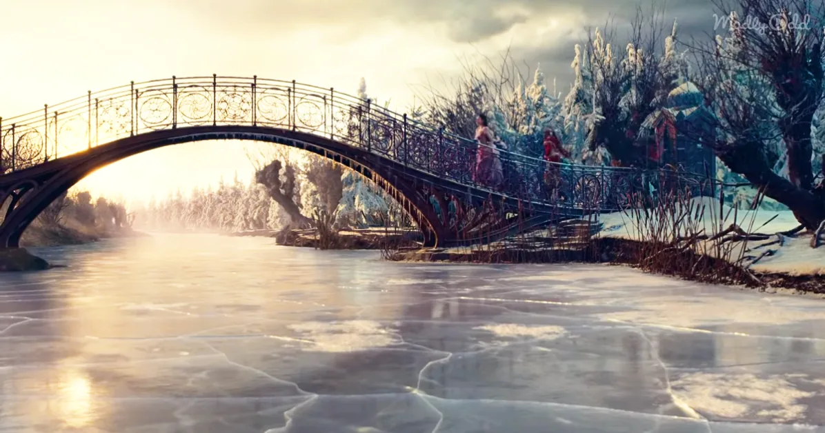 A frozen river with a decorative bridge, people walking, and snow-covered trees in the background.