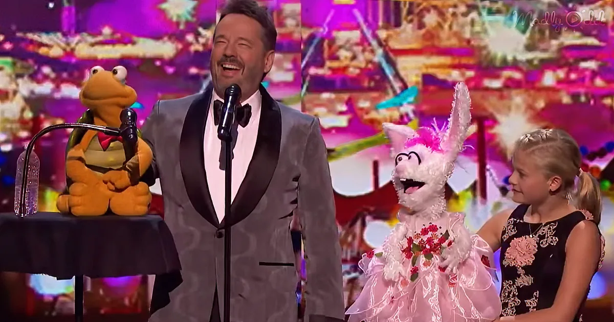 A man in a tuxedo sings into a microphone, flanked by a puppet and a young girl in a black dress.